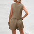 Woman wearing a beige sleeveless top and shorts set against a light gray background